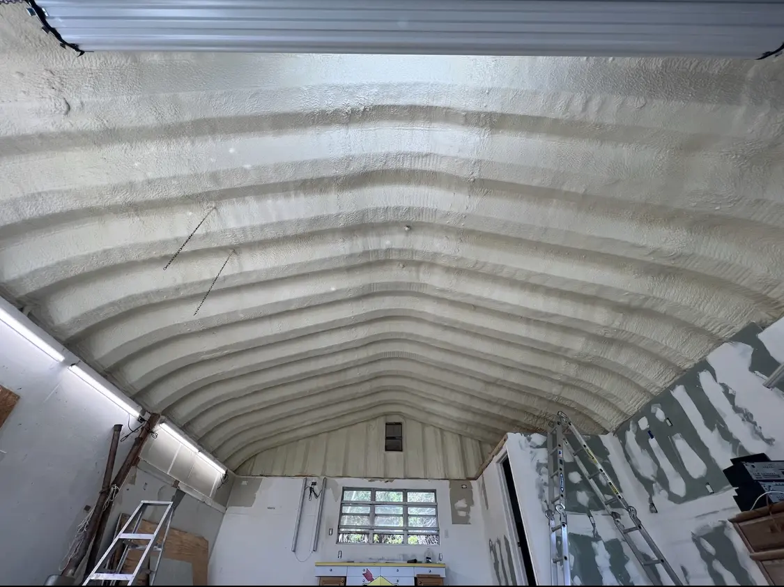 Spray polyurethane foam applied to the underside of a metal roof deck in Seagoville